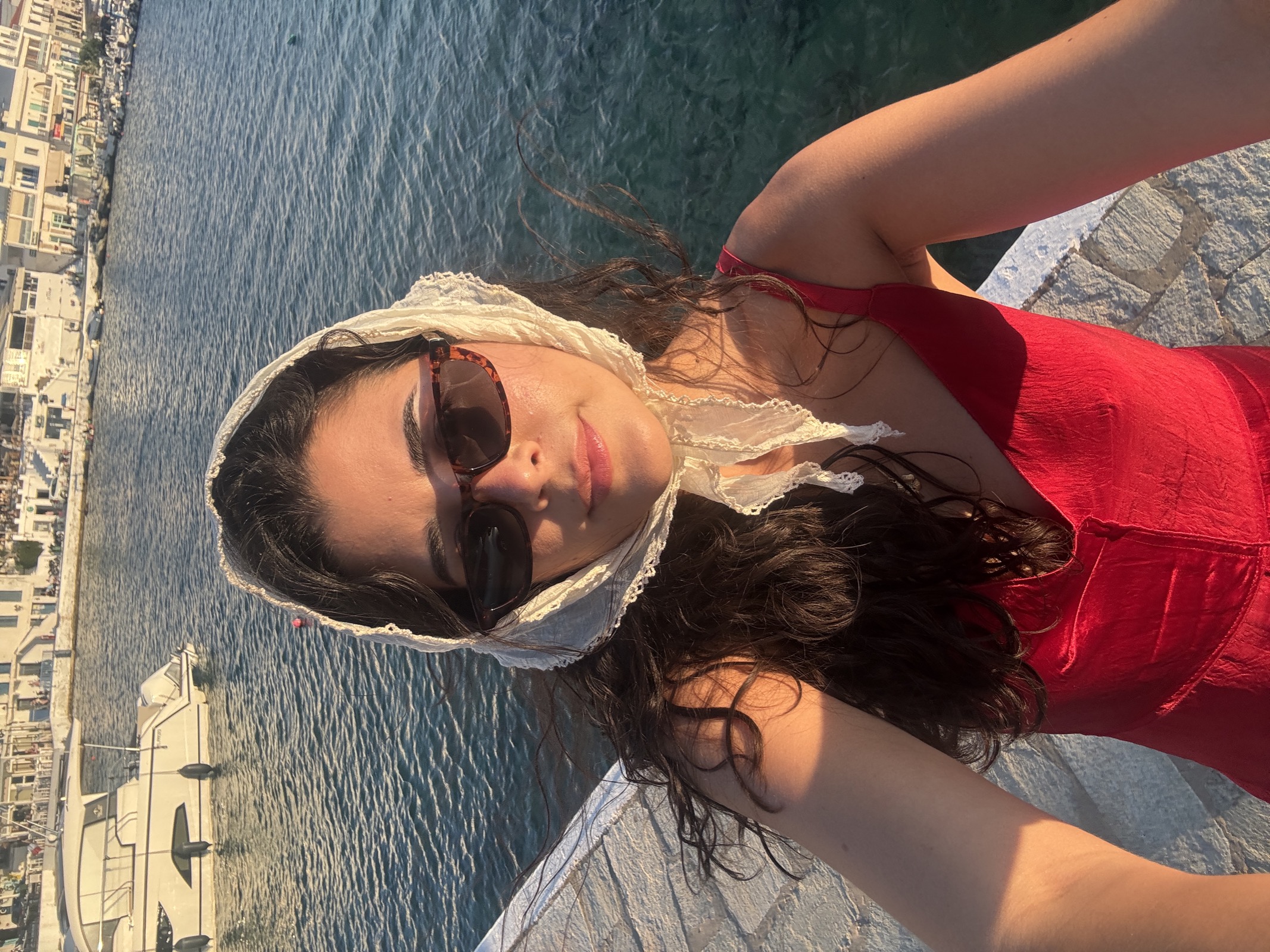 Caro in a red dress by the sea